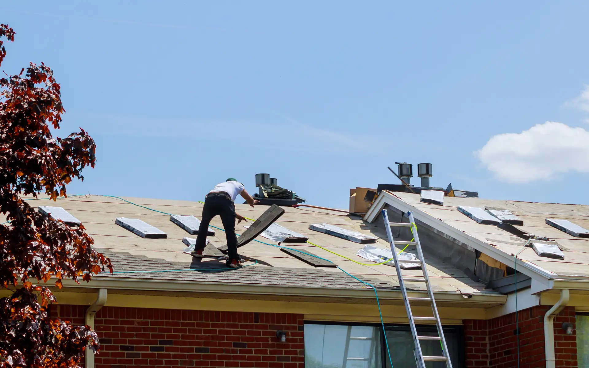 Roofers installing shingles on a Michigan home