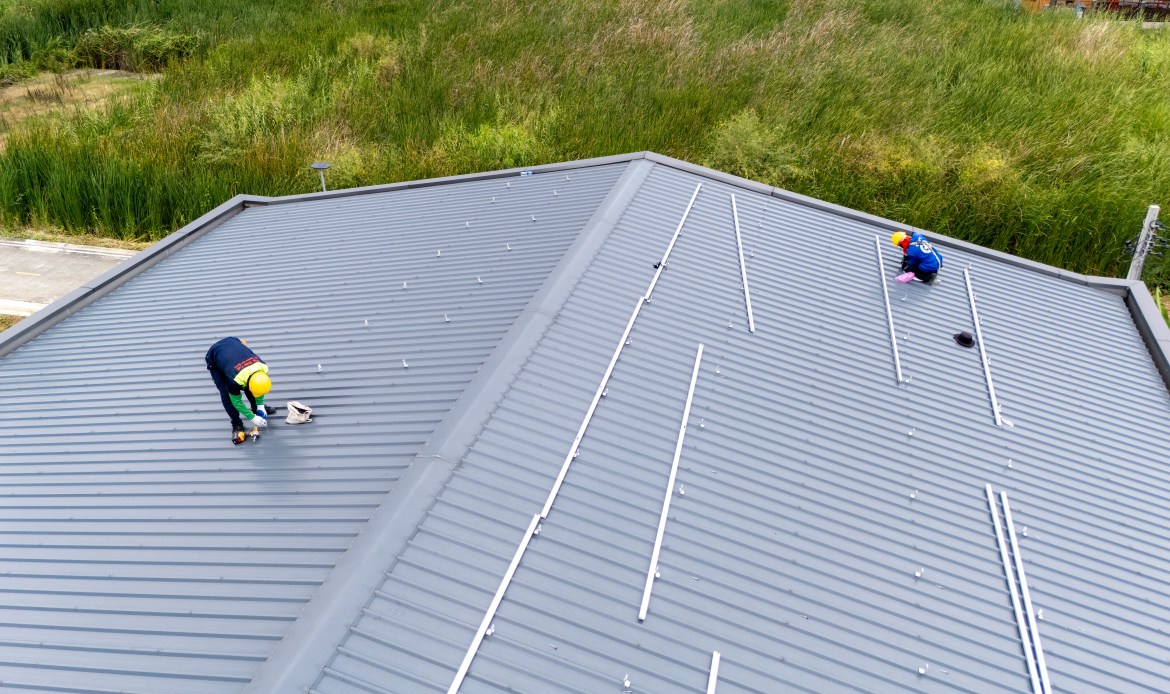 Technicians installing solar panels on West Michigan residential roof