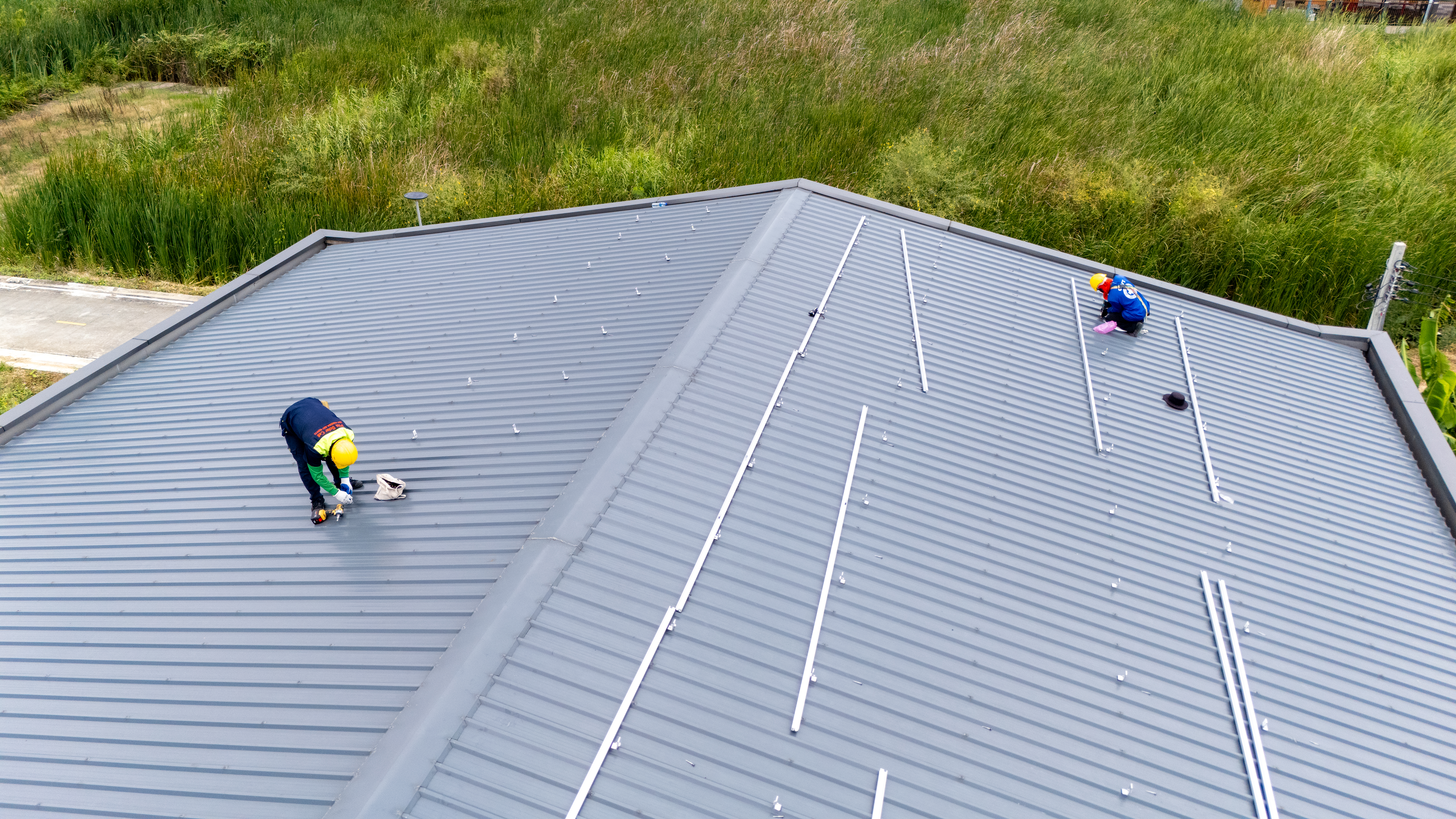 Technicians installing solar panels on West Michigan residential roof