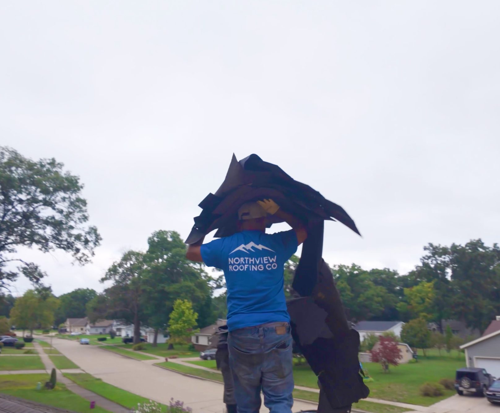 Northview roofer removing old siding for roof repair in Michigan